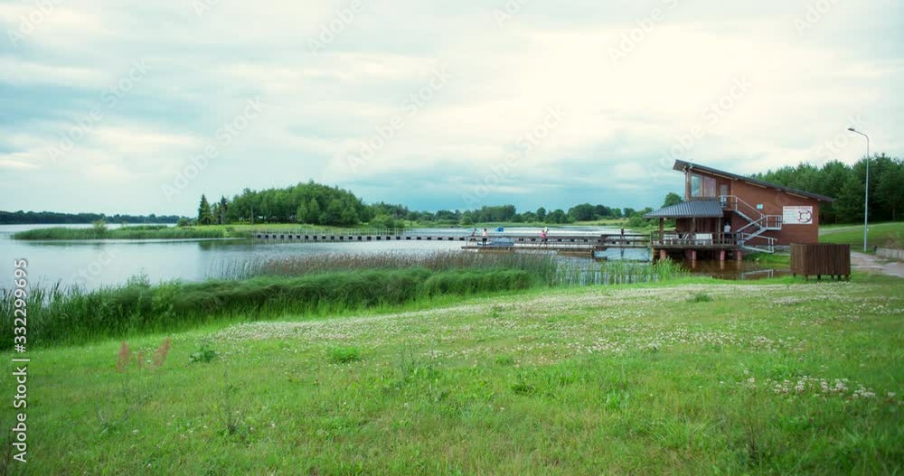 Wide shot of a country lakeside on a cloudy day