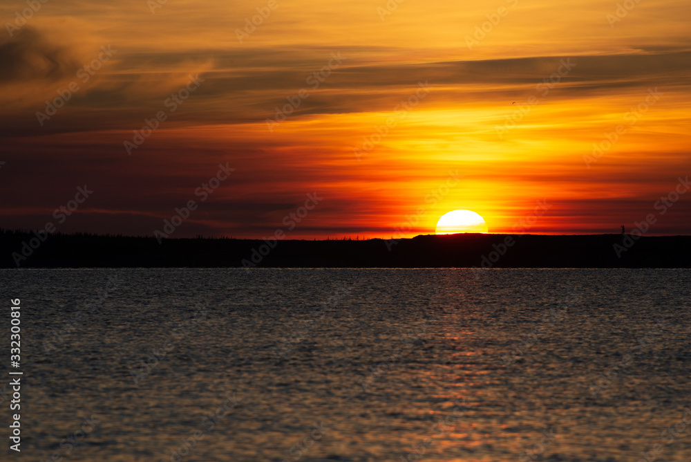 sunset over the churchill river in manitoba at the edge of the hudson bay