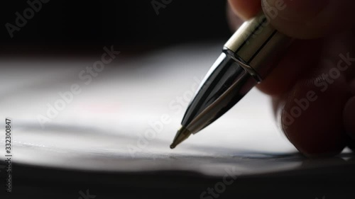 Close-up of pen writing on paper in 4K resolution