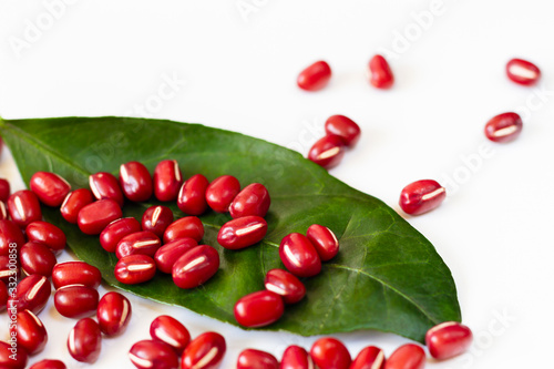 Red beans with a leaf on white background
