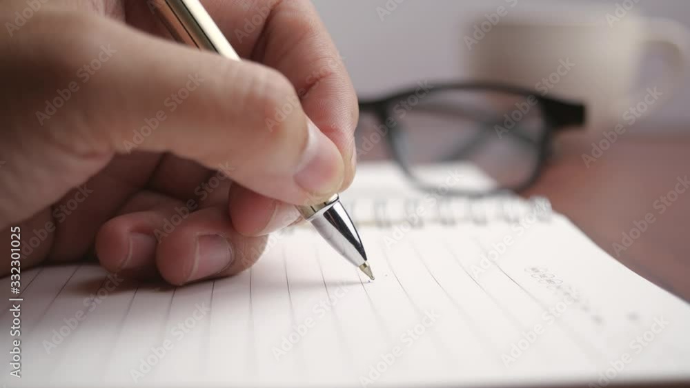 Pen writing on a book in 4K resolution Pen writing on a book in 4K resolution
