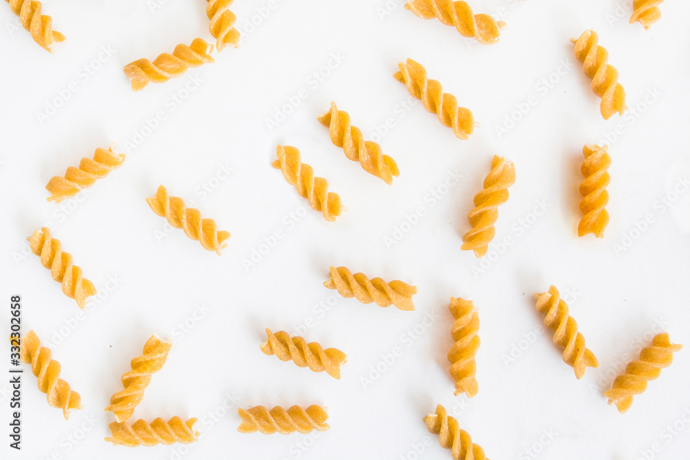 A raw macaroni on the white isolated background A raw macaroni on the white isolated background