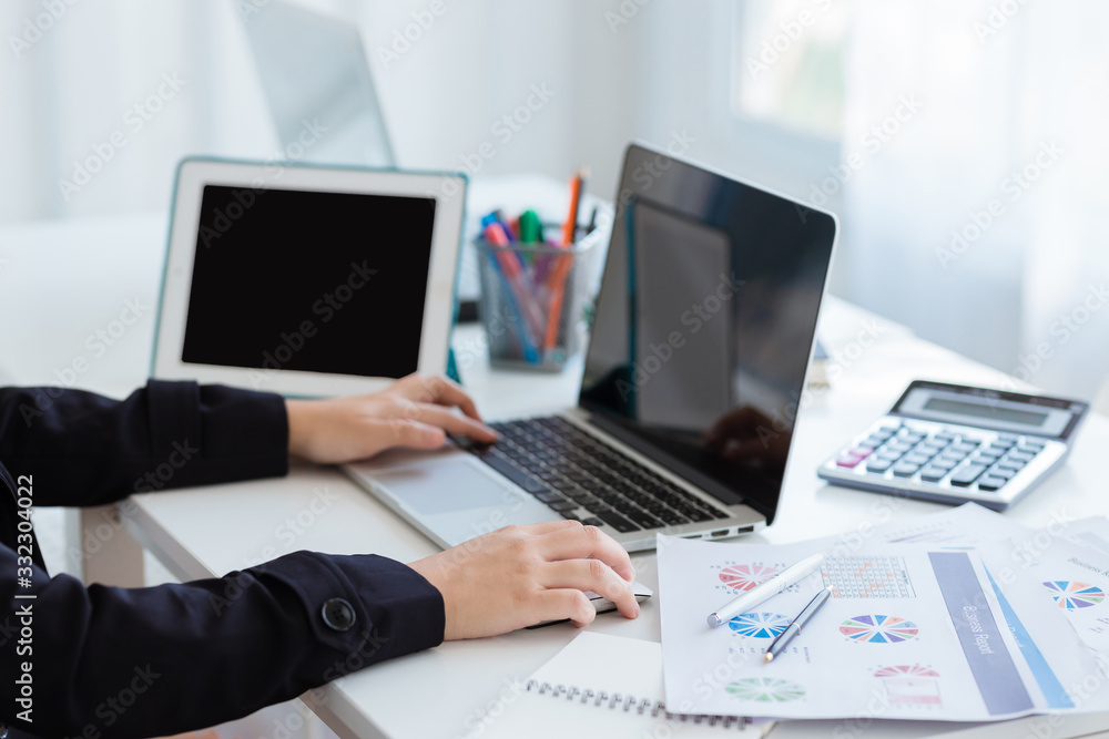 Business woman using a calculator to calculate the numbers on his desk in a office. Business woman using a calculator to calculate the numbers on his desk in a office.