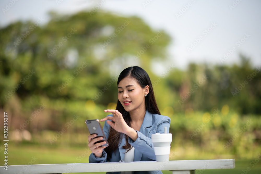 businesswomen working with laptop in the garden morning with coffee cup businesswomen working with laptop in the garden morning with coffee cup