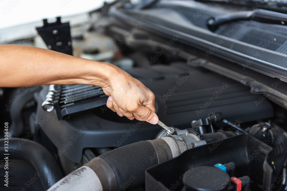 Mechanic Car Service Man is Working in Garage Workshop, Close-Up of Technician Automotive Hand is Inspection Checking and Repairing Mechanical Car Engine. Auto Services and Maintenance Concept Mechanic Car Service Man is Working in Garage Workshop, Close-Up of Technician Automotive Hand is Inspection Checking and Repairing Mechanical Car Engine. Auto Services and Maintenance Concept