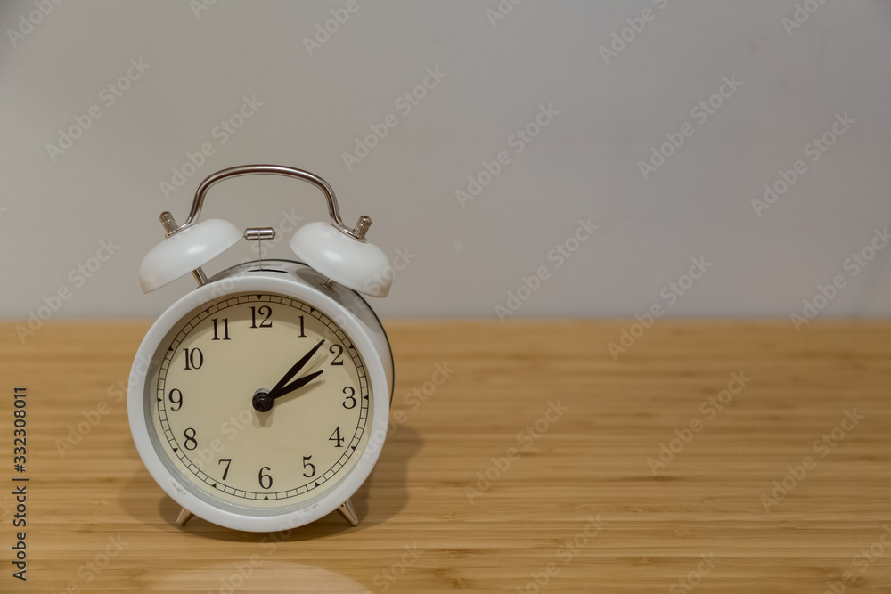 Alarm clock on the wood table beside the bed Alarm clock on the wood table beside the bed