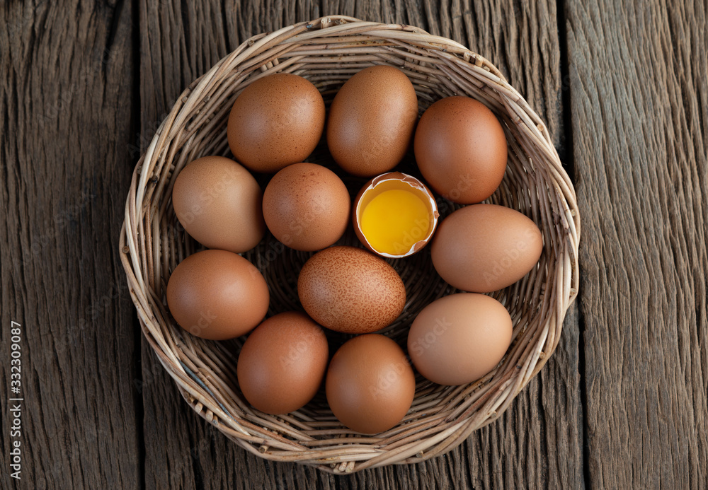 Lay eggs in a wooden basket on a wooden floor. Lay eggs in a wooden basket on a wooden floor.