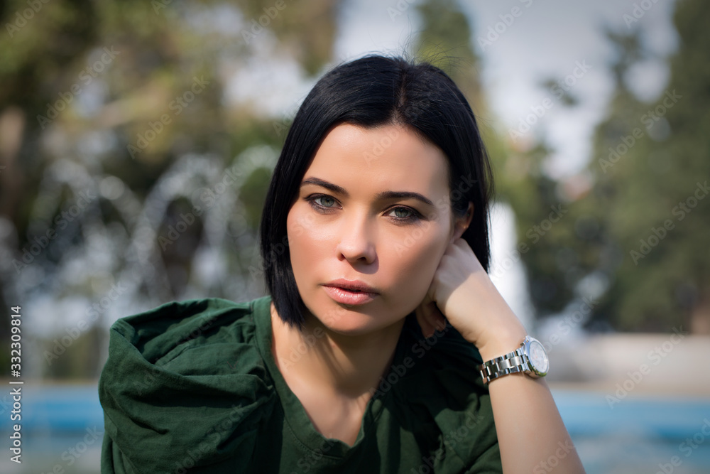 Beautiful girl enjoying nature outdoors in a park. The girl laughs and rejoices, a positive emotion. Beautiful girl enjoying nature outdoors in a park. The girl laughs and rejoices, a positive emotion.
