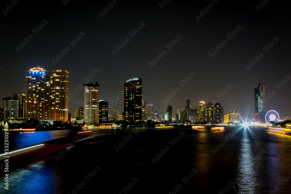 Fototapeta premium City at night with light bokeh and water reflection