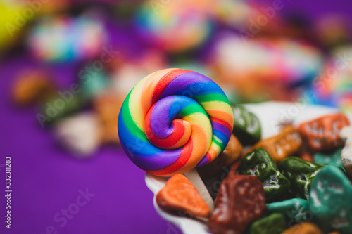 Lollipops and candy pebbles. sweets in the form of colored stones. colored background with colorful candies