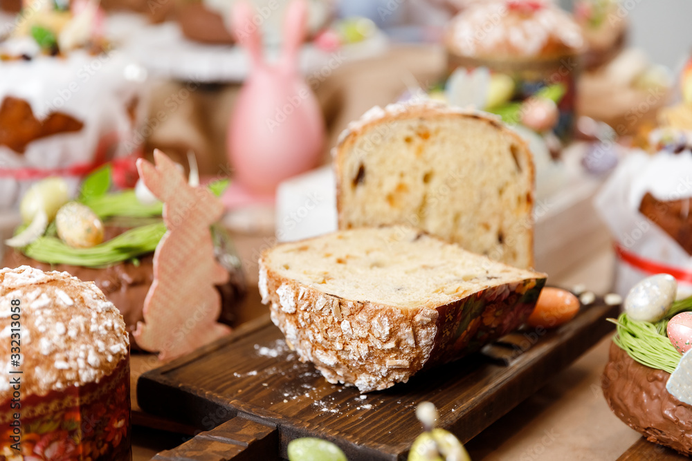 Easter table orthodox sweet bread, kulich with chocolate eggs and rabbit. Variety pastries for holiday