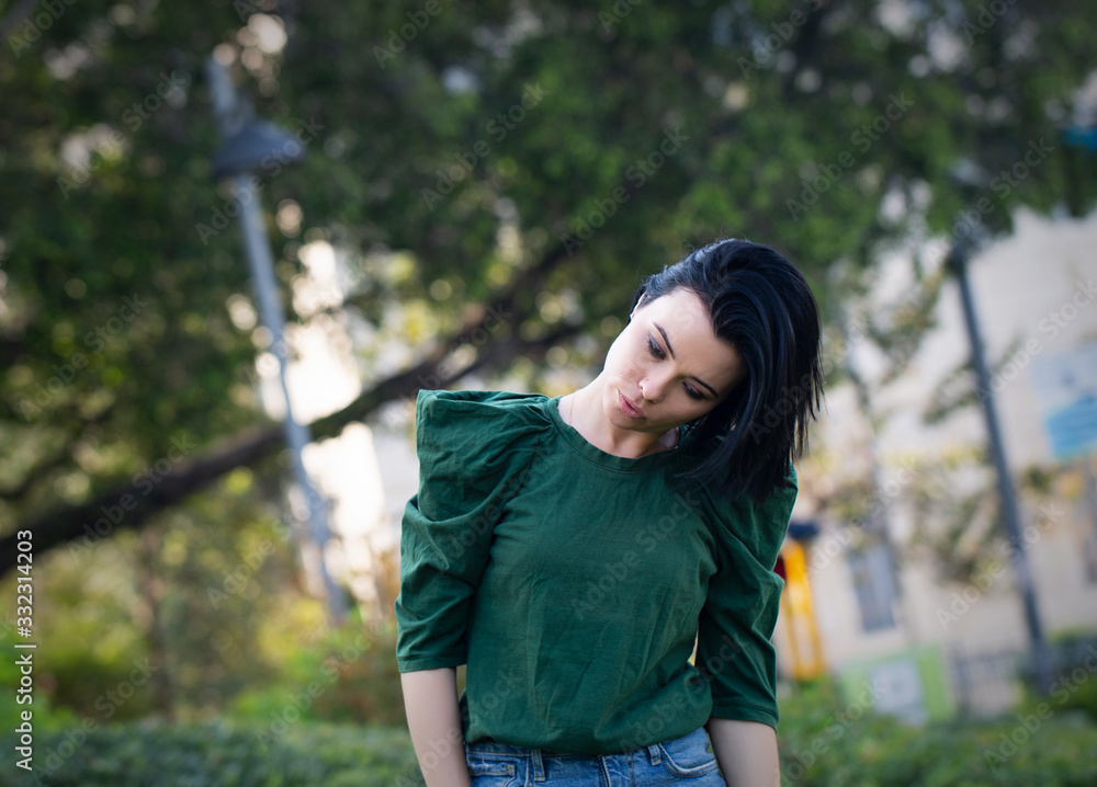 Beautiful girl enjoying nature outdoors in a park. The girl laughs and rejoices, a positive emotion. Beautiful girl enjoying nature outdoors in a park. The girl laughs and rejoices, a positive emotion.
