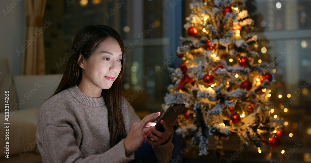 Woman use of mobile phone at Christmas time Woman use of mobile phone at Christmas time