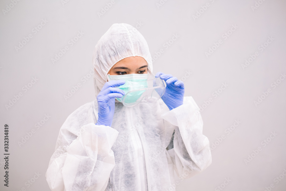 Young Nurse with disposable coverall wearing sterile gloves preparing take care of Pandemic 2019 Coronavirus 2019-nCoV. Young Nurse with disposable coverall wearing sterile gloves preparing take care of Pandemic 2019 Coronavirus 2019-nCoV.