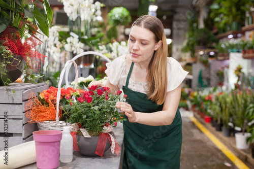 Female florist wearing an apron working in the floral shop