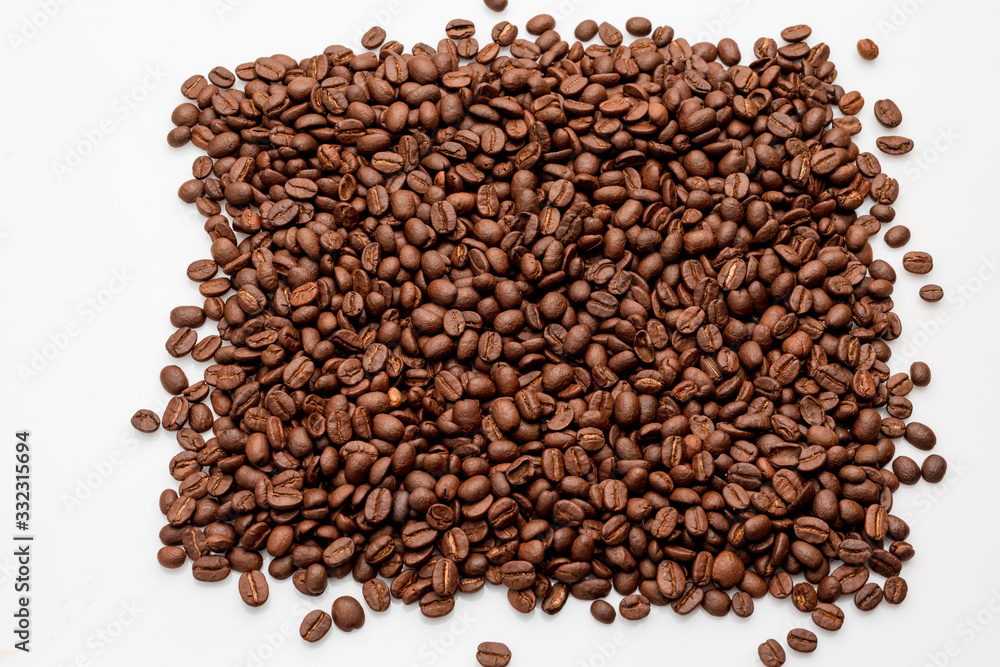 coffee beans close up on a white isolated background,copy space. coffee beans close up on a white isolated background,copy space.