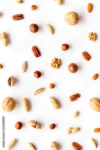 Nuts background - with almond, macadamia, walnut - on white table top-down