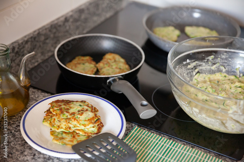 Plate with hot zucchini fritters