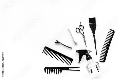 Professional hairdressing set with combs  spray and sciccors on white background top-down copy space