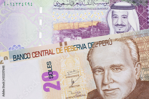 Wallpaper Mural A pastel colored, twenty Peruvian sol bank note, close up in macro with a colorful Saudi five riyal bank note Torontodigital.ca