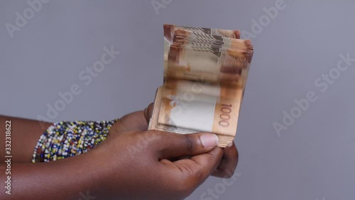 Counting Kenyan shillings. Close up of female hands count money cash. Employee salary. Cash money payment . photo