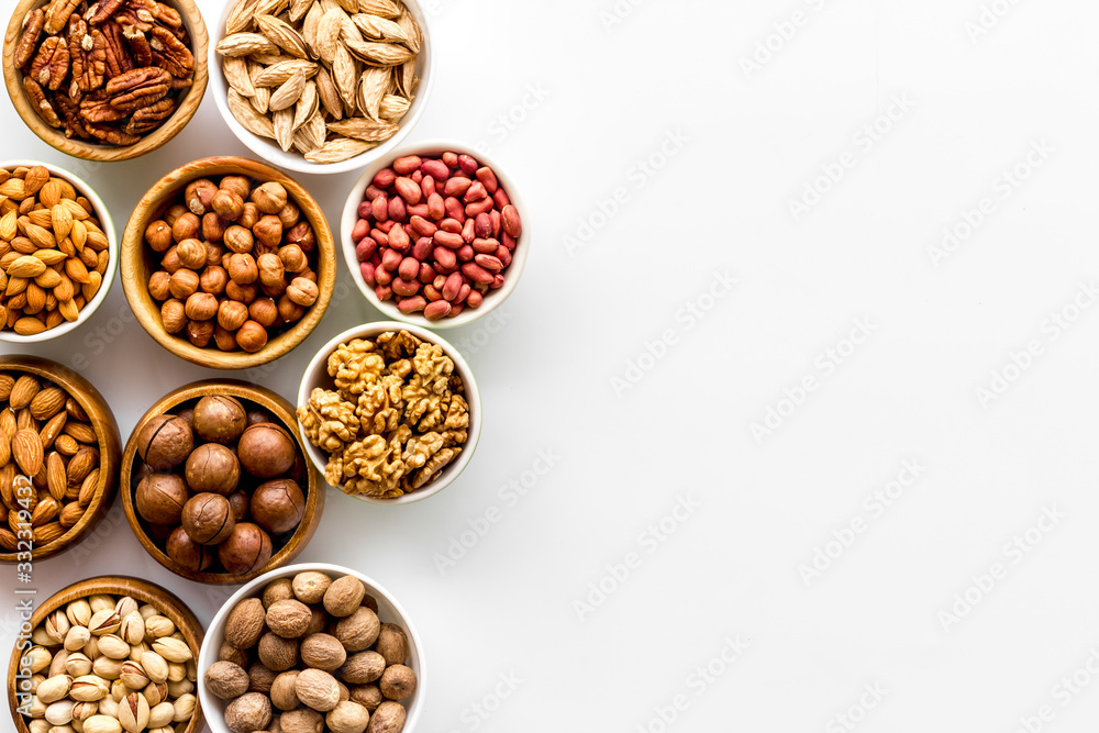 Set of macadamia, hazelnut, walnut, almond, pistachio, pecans nuts on white background top-down frame copy space Set of macadamia, hazelnut, walnut, almond, pistachio, pecans nuts on white background top-down frame copy space