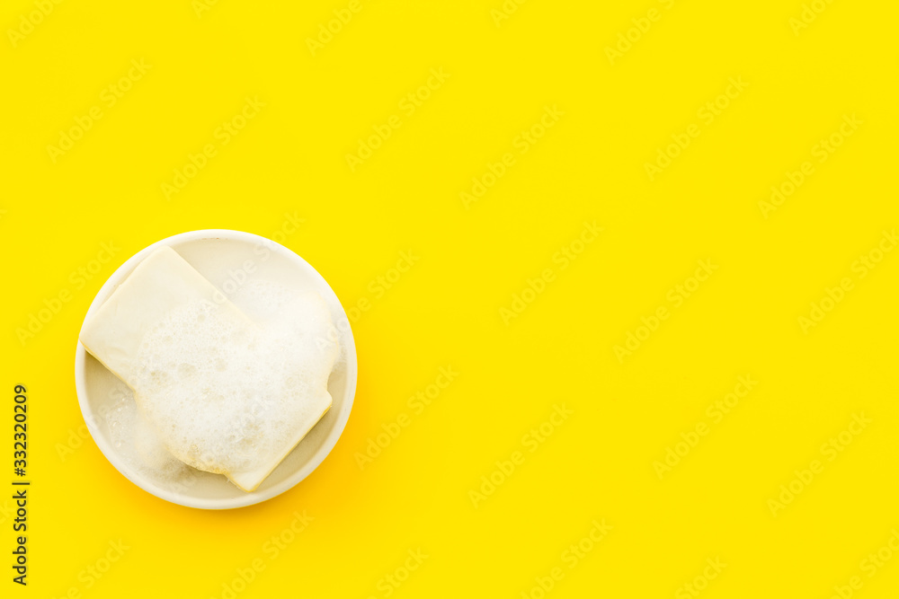 Soap bar - hygiene concept - on yellow background top-down copy space Soap bar - hygiene concept - on yellow background top-down copy space
