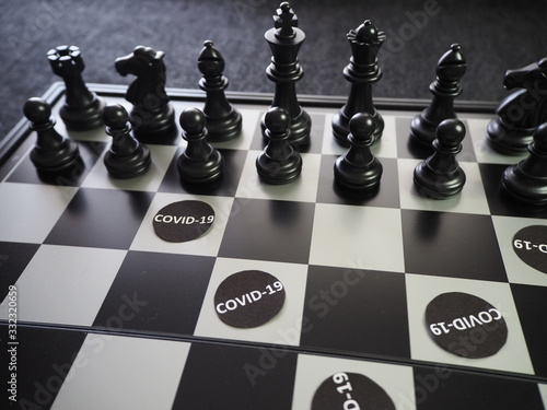 Chess pieces battling against  COVID-19  photo