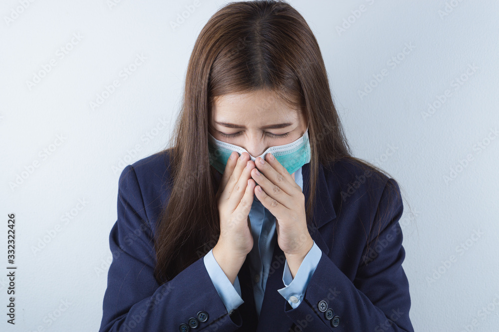 The business girl wearing mask for protecting coronavirus and pm 2.5 and she coughing flu from coronavirus. Coronavirus and Air pollution pm 2.5 concept. The business girl wearing mask for protecting coronavirus and pm 2.5 and she coughing flu from coronavirus. Coronavirus and Air pollution pm 2.5 concept.