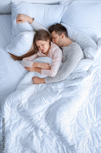 Young couple sleeping in bed