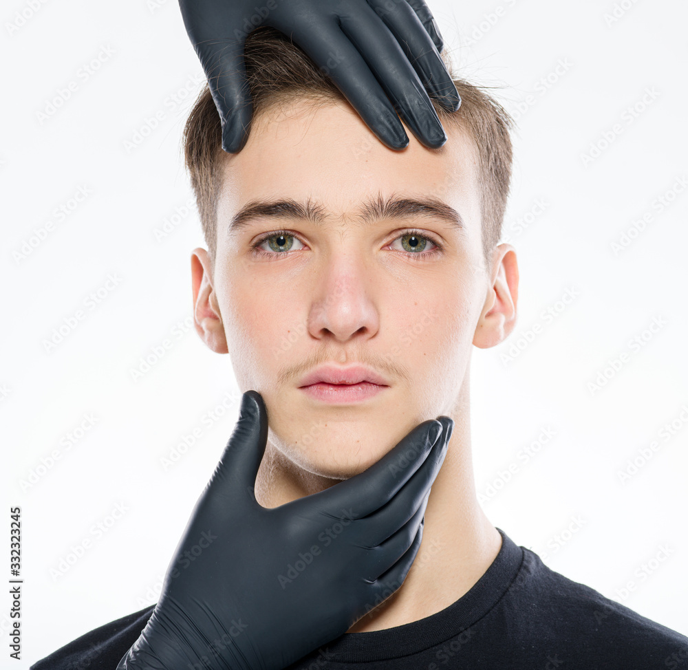 Face skin check. Beautician touching male face. Doctor checks a skin