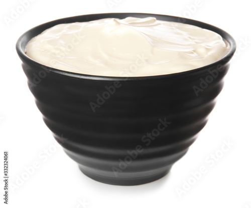 Bowl with tasty sour cream on white background