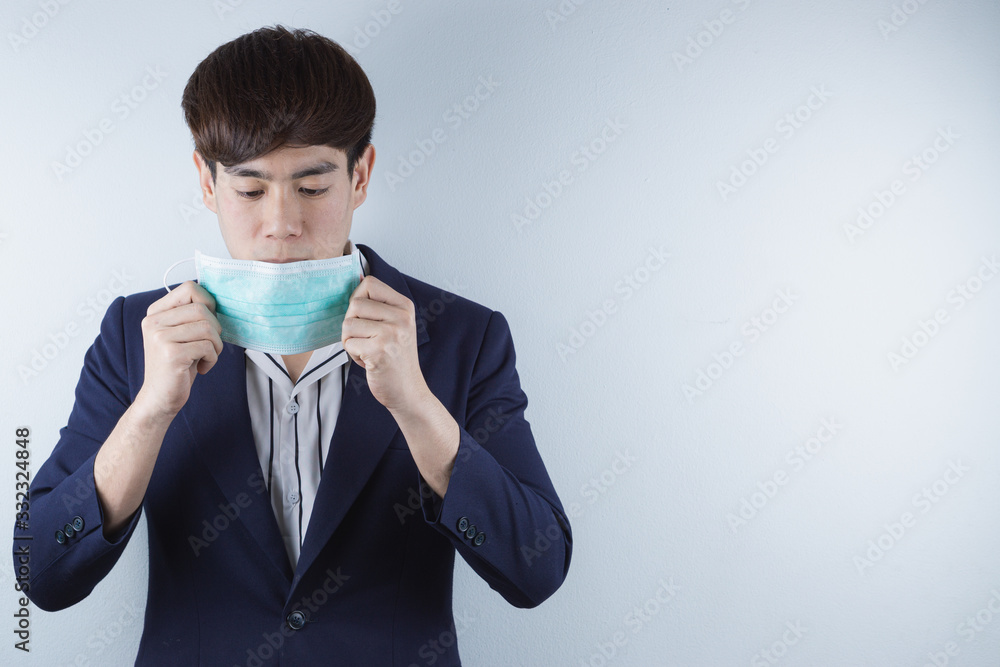 The business man wearing protection face mask against coronavirus, PM 2.5 and cold. Coronavirus and Air pollution pm 2.5 concept. The business man wearing protection face mask against coronavirus, PM 2.5 and cold. Coronavirus and Air pollution pm 2.5 concept.