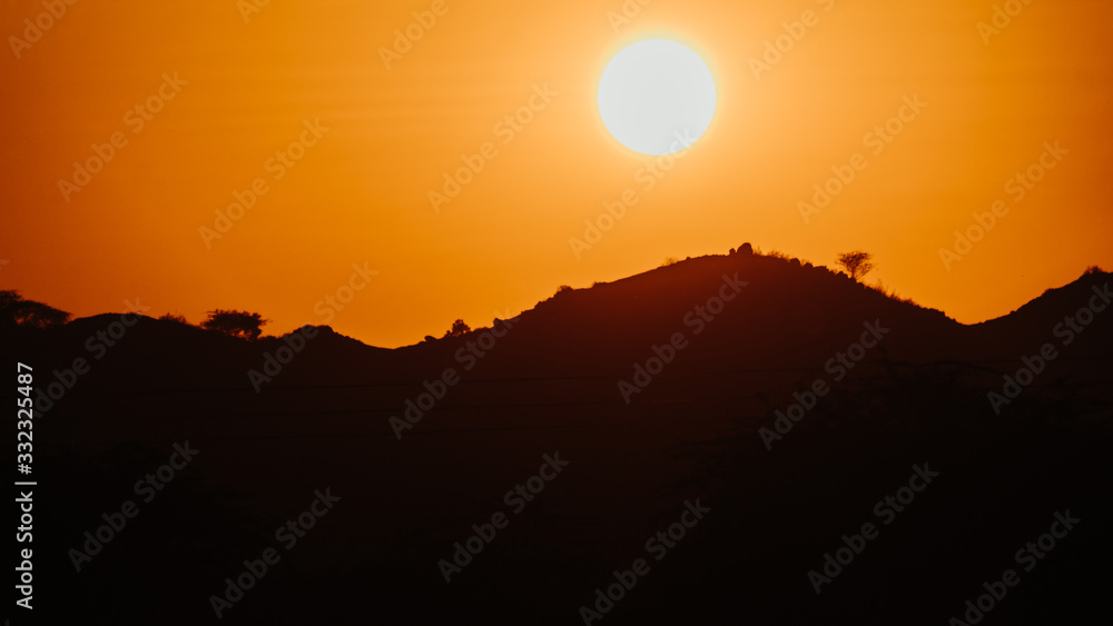Sun besides the mountain during sunset at Mount Abu in Rajasthan, India