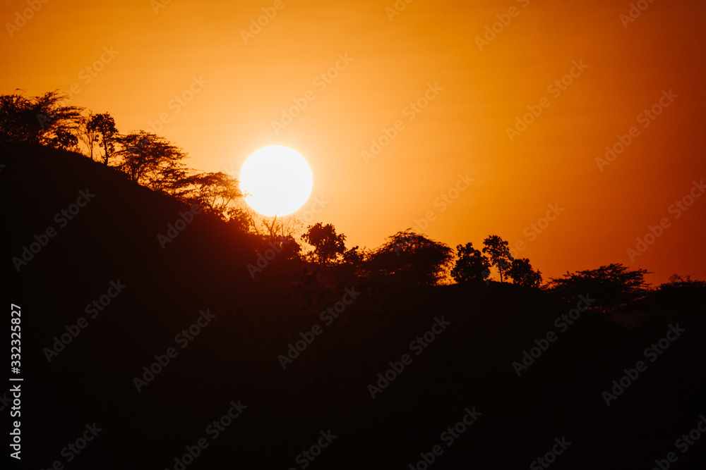 Sun besides the mountain during sunset at Mount Abu in Rajasthan, India Sun besides the mountain during sunset at Mount Abu in Rajasthan, India