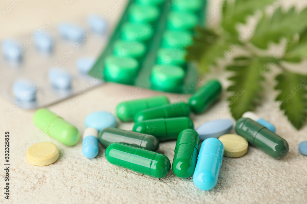 Plant based pills on grey background, closeup Plant based pills on grey background, closeup