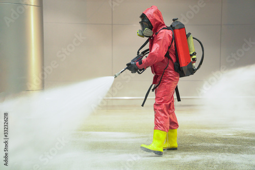 medical officers prepare chemical protection suit or hazmat (hazardous material) suits and working in airport area to cleaning virus with anti bacteria chemical
