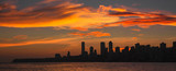 Panoramic Image of Mumbai's Ever Growing Beautiful City Skyline silhouetted during Sunset with colorful clouds. Taken from Marine Drive, Mumbai, Maharashtra, India.