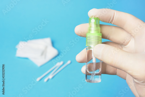 antiseptic sanitizer in a bottle with a spray in hand in rubber gloves.