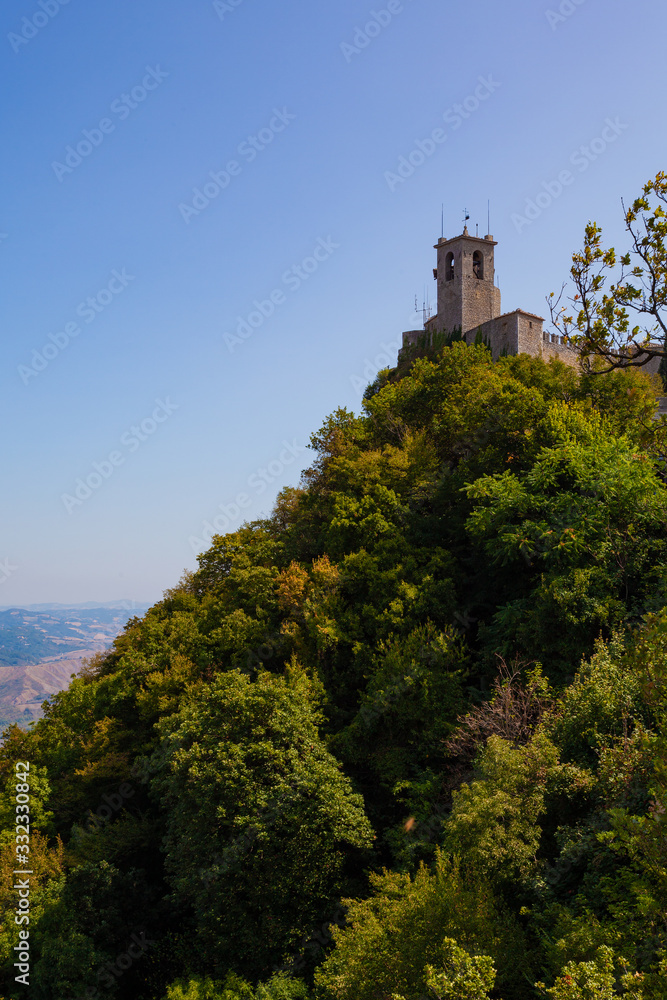 A cliff watchtower surrounded by a forest in San Marino (Italy)