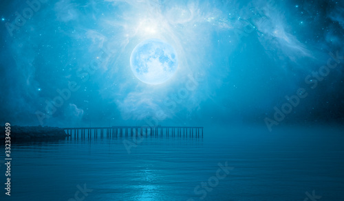 Night sky with full moon in the clouds with pier on the background The Sword of Orion  Elements of this image furnished by NASA