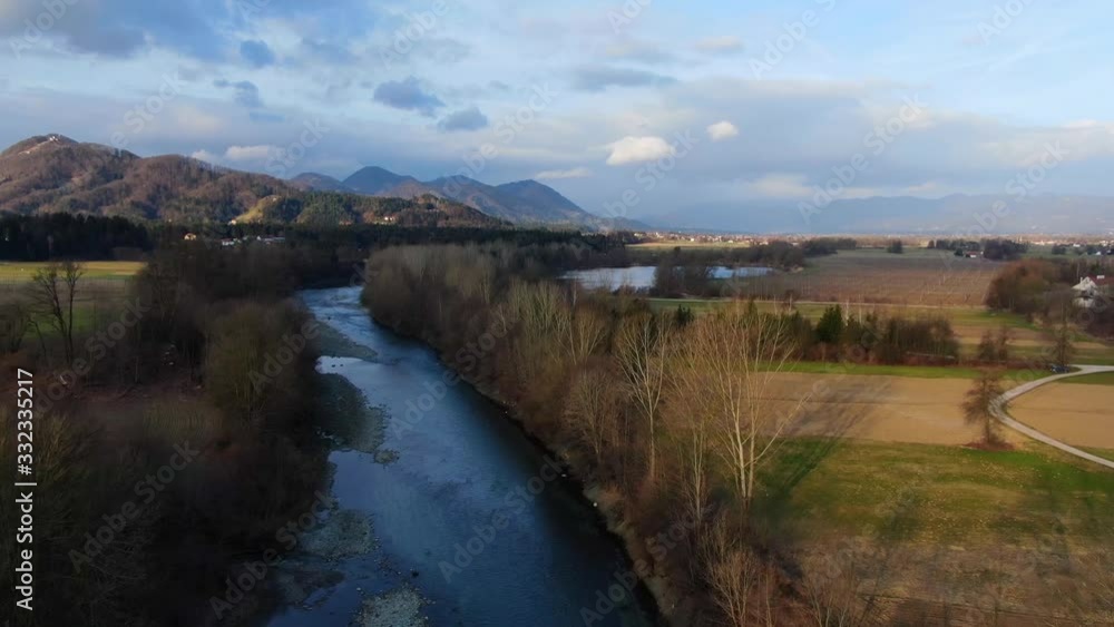 The Savinja River near Vrbje Slovenia at golden hour afternoon, Aerial flyover shot The Savinja River near Vrbje Slovenia at golden hour afternoon, Aerial flyover shot
