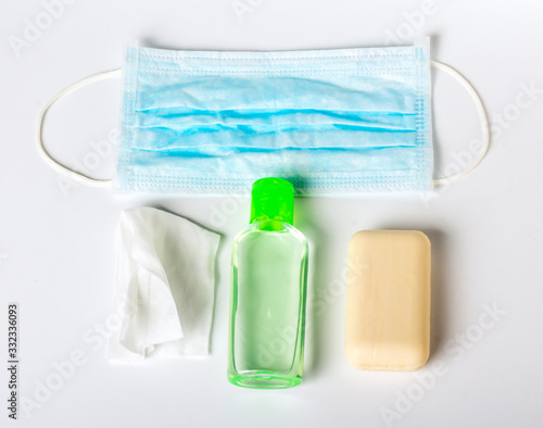 flatley coronavirus prevention antibacterial wipes with soap and disinfecting gel for hands and a medical mask against the virus on a white background photo