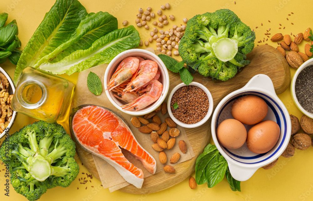 Omega 3 food sources and omega 6 on yellow background top view. Foods