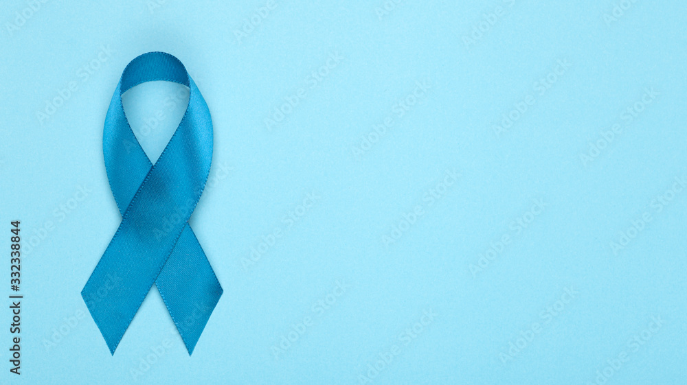 Blue ribbon on background. Prostate cancer awareness month. Blue ribbon symbol of world prostate cancer month and concept of healhcare. Copy space Blue ribbon on background. Prostate cancer awareness month. Blue ribbon symbol of world prostate cancer month and concept of healhcare. Copy space