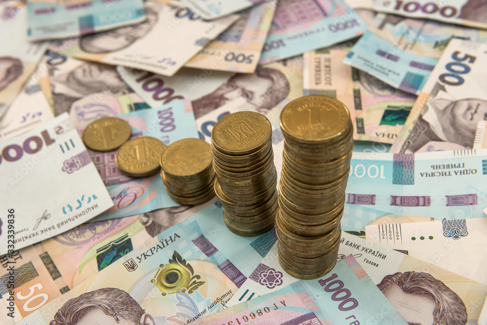 diagram of coin money growth effect with lot of ukraine money banknotes. For business growth and financial concept diagram of coin money growth effect with lot of ukraine money banknotes. For business growth and financial concept