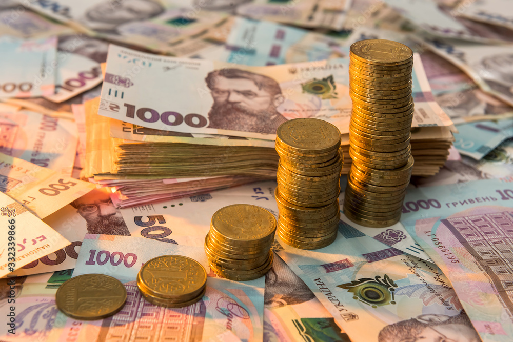 Close up coin stacked growing as financial chart lying on ukraine money as background. For business growth Close up coin stacked growing as financial chart lying on ukraine money as background. For business growth