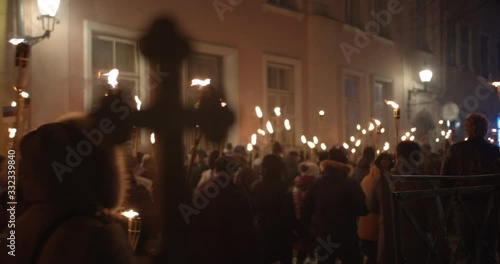 Torchlight procession protest march at night people walk with burning torches