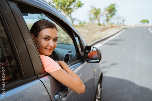 happy young woman smiling while sitting in her car