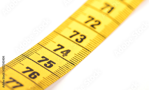 Close-up of a yellow measuring tape isolated on white - 75